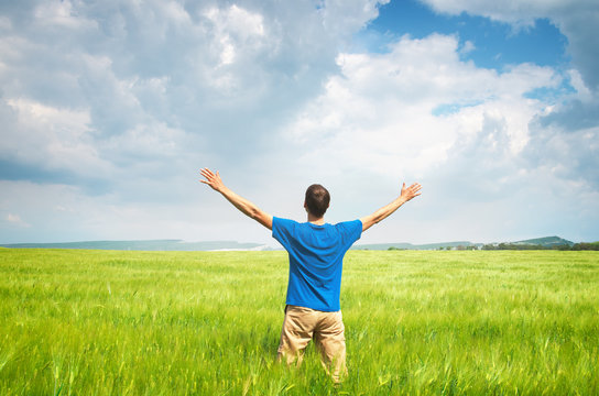 Man in green wheat meadow.