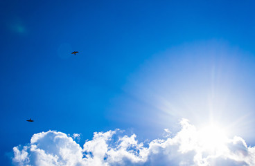 bright blue sky clouds and sun rays