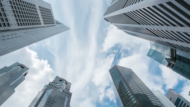 Timelapse skyline of highrise buildings at Singapore with blue sky
