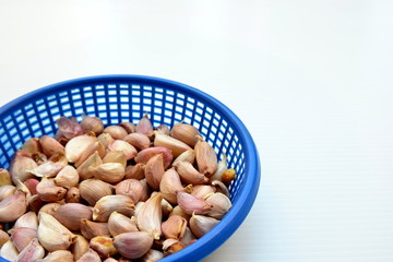 Garlic in blue plastic backet