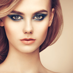 Fototapeta premium Portrait of beautiful sensual woman with elegant hairstyle. Perfect makeup. Beauty fashion. Eyelashes. Lips. Cosmetic Eyeshadow