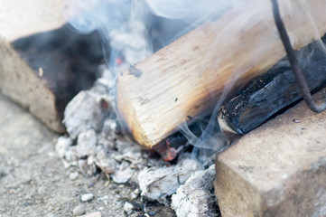 Macro shot of smoking and burning wood