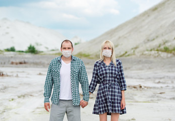 The man and the woman in respirators. Protection against viruses.