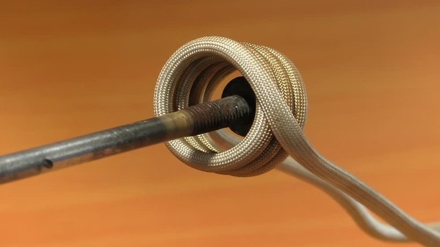 Rusty bolt with nut inserted into the induction heating coil soon becomes hot and red due to high frequency magnetic fields which generate heat in the ferrous metal inside coil