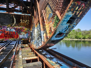 Industrial old metal train drawbridge with vibrant graffiti in Providence, RI