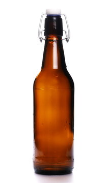 old bottle of beer with drops isolated on white background
