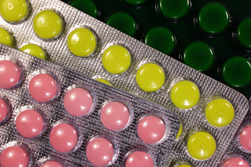 Colorful tablets and capsules in blister pack closeup