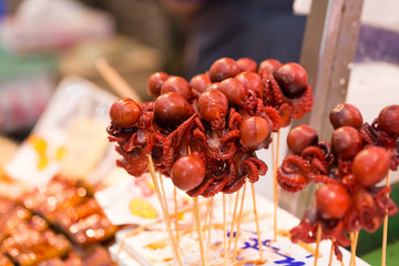 baby octopus stick, red marinated baby octopus in stick selling in fresh market, Japan