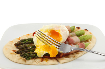 Poached and asparagus with fork