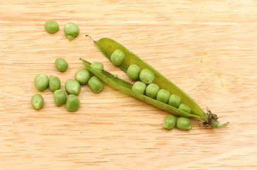 Peas on a wooden chopping board