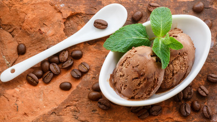 Coffee ice cream with mint leaves in a white Cup