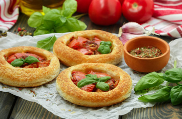 Homemade pie of puff pastry with tomatoes, Basil and spices