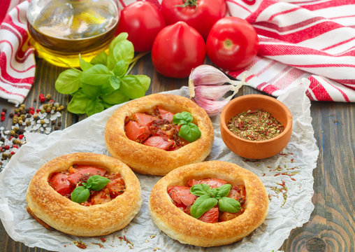 Homemade pie of puff pastry with tomatoes, Basil and spices