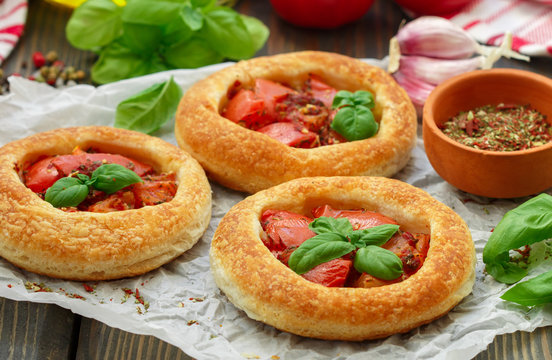 Homemade pie of puff pastry with tomatoes, Basil and spices