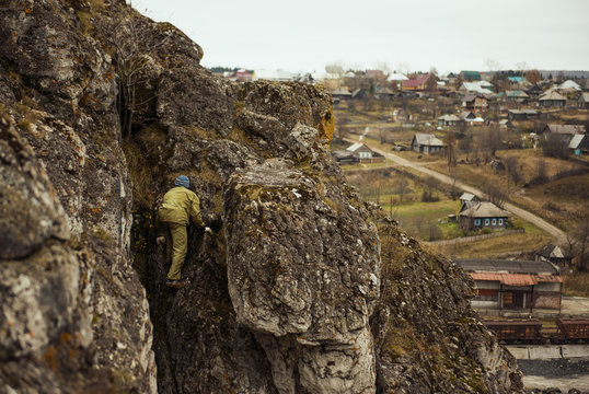 Hiker climbing at rocky mountainside