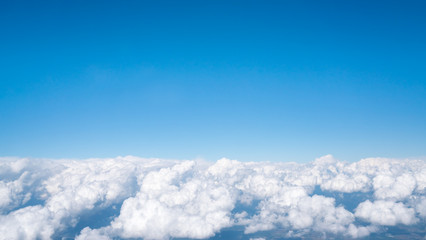Blue sky above white fluffy cloud, cloudscape background with copy space