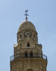 Fototapeta na wymiar Clock tower with a weathercock