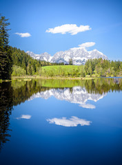 Wilder Kaiser reflecting in mountain lake, Kitzbühel, Tyrol, Austria