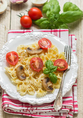 Warm salad of Farfalle with mushrooms and tomatoes 
