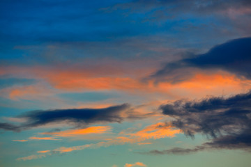 Obraz premium Sunset orange clouds in a blue sky