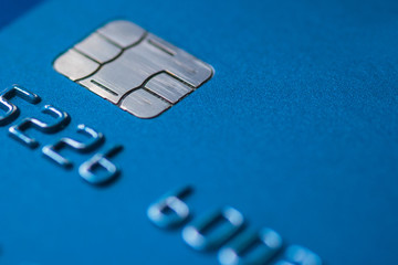 Credit Card blue with chip partial number selective focus close up macro empty space atm emv