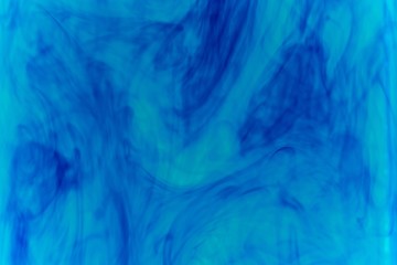 Abstract pattern falling into the water drop of blue ink - cyan ink dissolved in water
