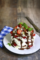 Chocolate pancakes with ricotta and strawberry.