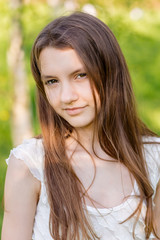 Fototapeta premium portrait of a beautiful happy girl outdoors in summer