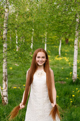 portrait of a beautiful red-haired girl in summer