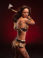 Young strong woman with axe in hand. Riot woman