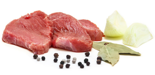 Raw beef with pepper, bay leaf and onion isolated on white