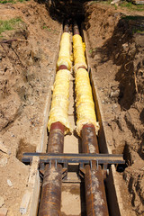 steel pipe with heat insulation on construction site. Insulation. metal pipe with heat insulation in the ground