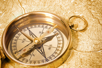 Fototapeta na wymiar Golden compass on old map