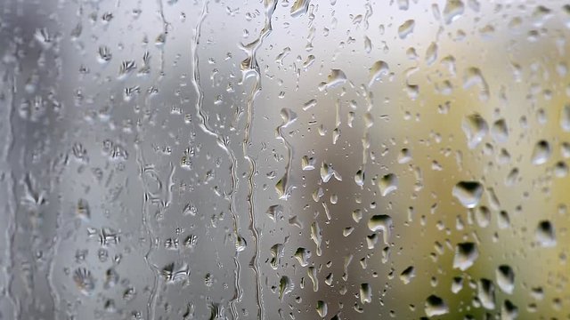 Color footage of some raindrops on a window, with selective focus.