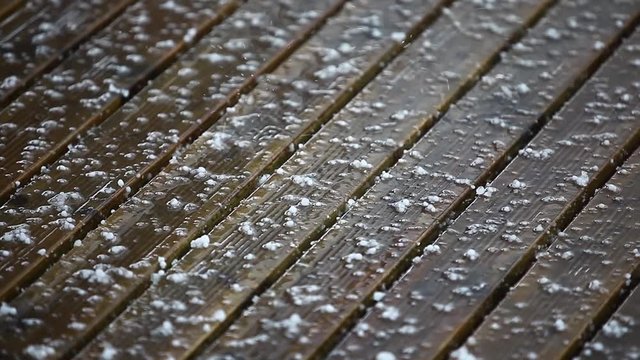 Footage of a hailstorm, with ice falling on the ground.
