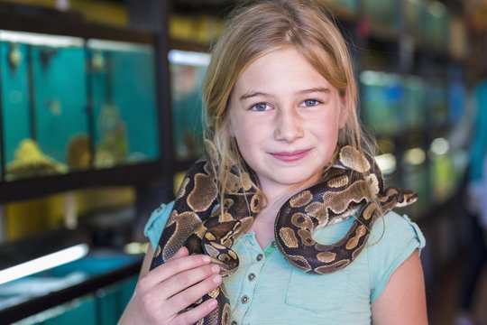 Portrait of girl holding snake