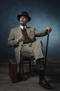 Fashionable Vintage 1940 Business Man With Cane Sitting On Chair