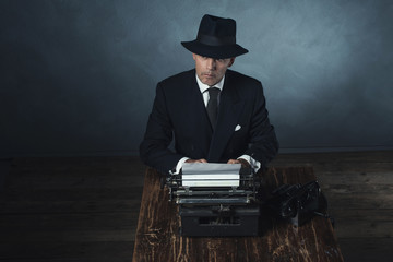 Vintage 1940 office worker behind desk with typewriter and telep