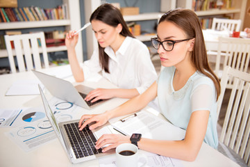 Concentrated colleagues sitting at the table  