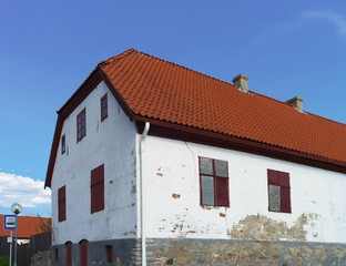 White painted Old house with red roof in Ventspils