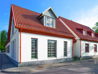 White painted houses with red roof in Ventspils