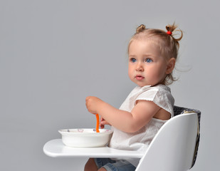 child toddler kid sitting with plate and spoon on white baby cha