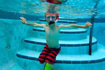 little boy swimming underwater