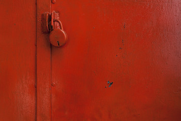 Red color painted wall with red color lock