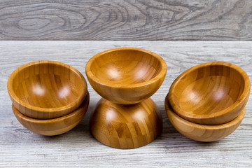Top view of wooden bowl on wooden background
