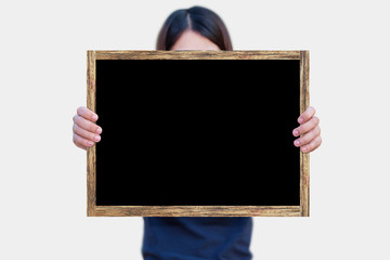 Woman holding blackboard wooden frame on white background isolated.