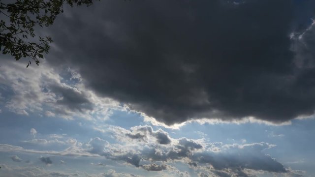 The Sun Coming Out From Behind Dark Clouds Time Lapse