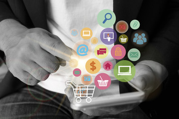 Young man are using shopping cart with application software icon