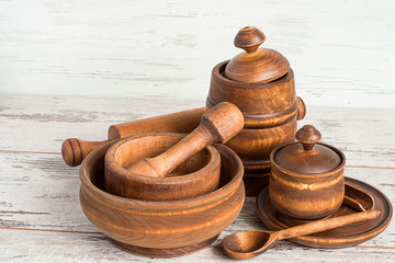Wooden kitchen utensils.   Wooden kitchen utensils on a light wooden background.