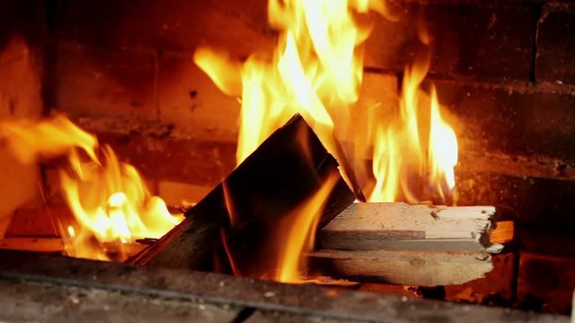 Rural life. Burning chop wood in the stone fire-place from fire-bricks.
